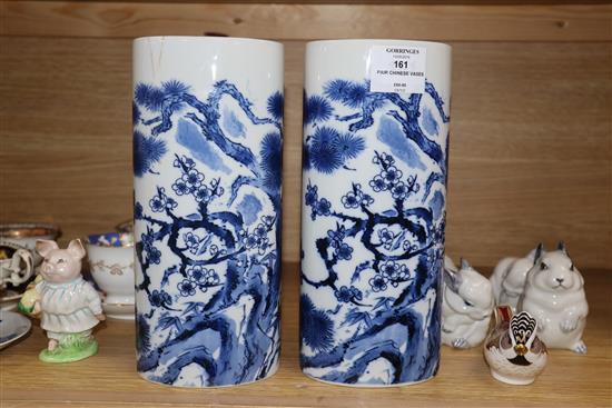 A pair of Chinese blue and white oval section sleeve vases height 25cm (one a.f.)